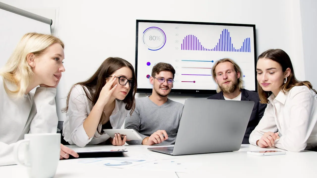 services-01 group of Business professionals using workplace monitoring software in modern office